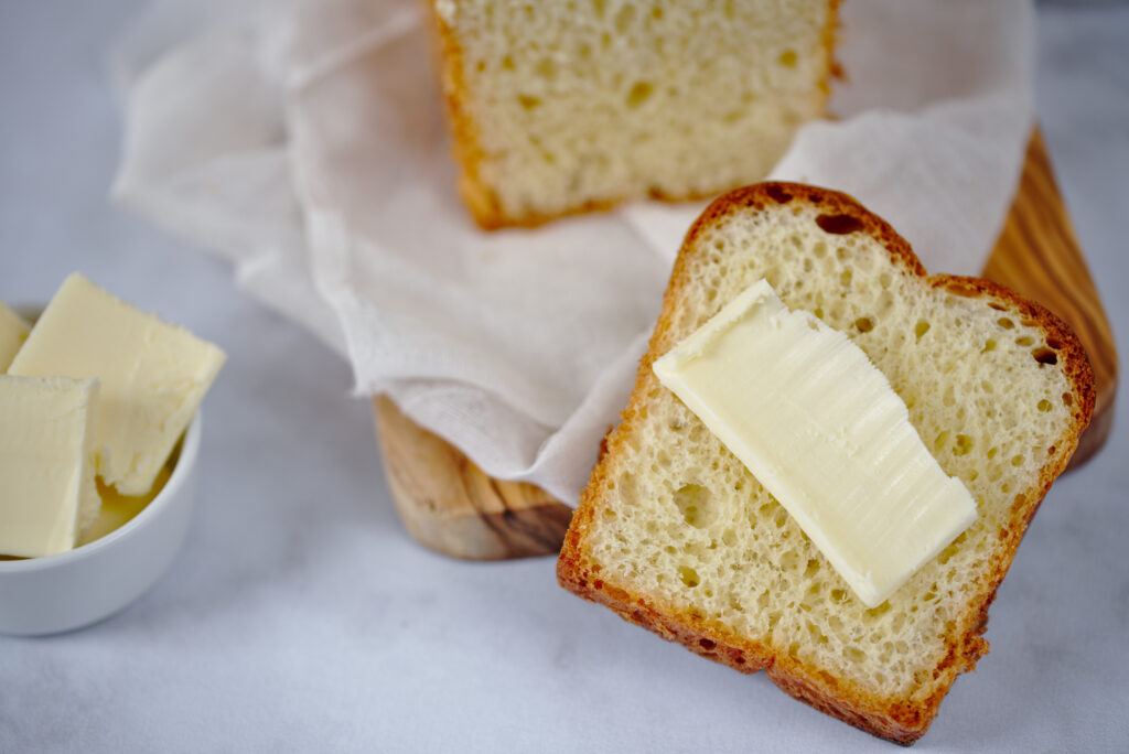 close up photo of french brioche with butter