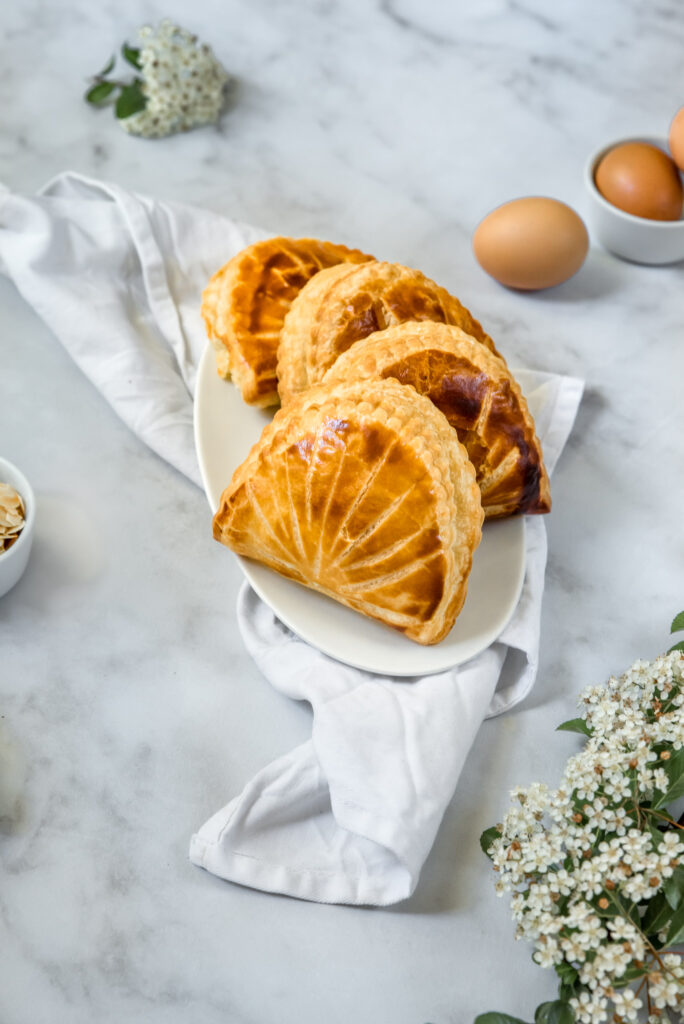 almond turnovers with some raw ingredients in the background